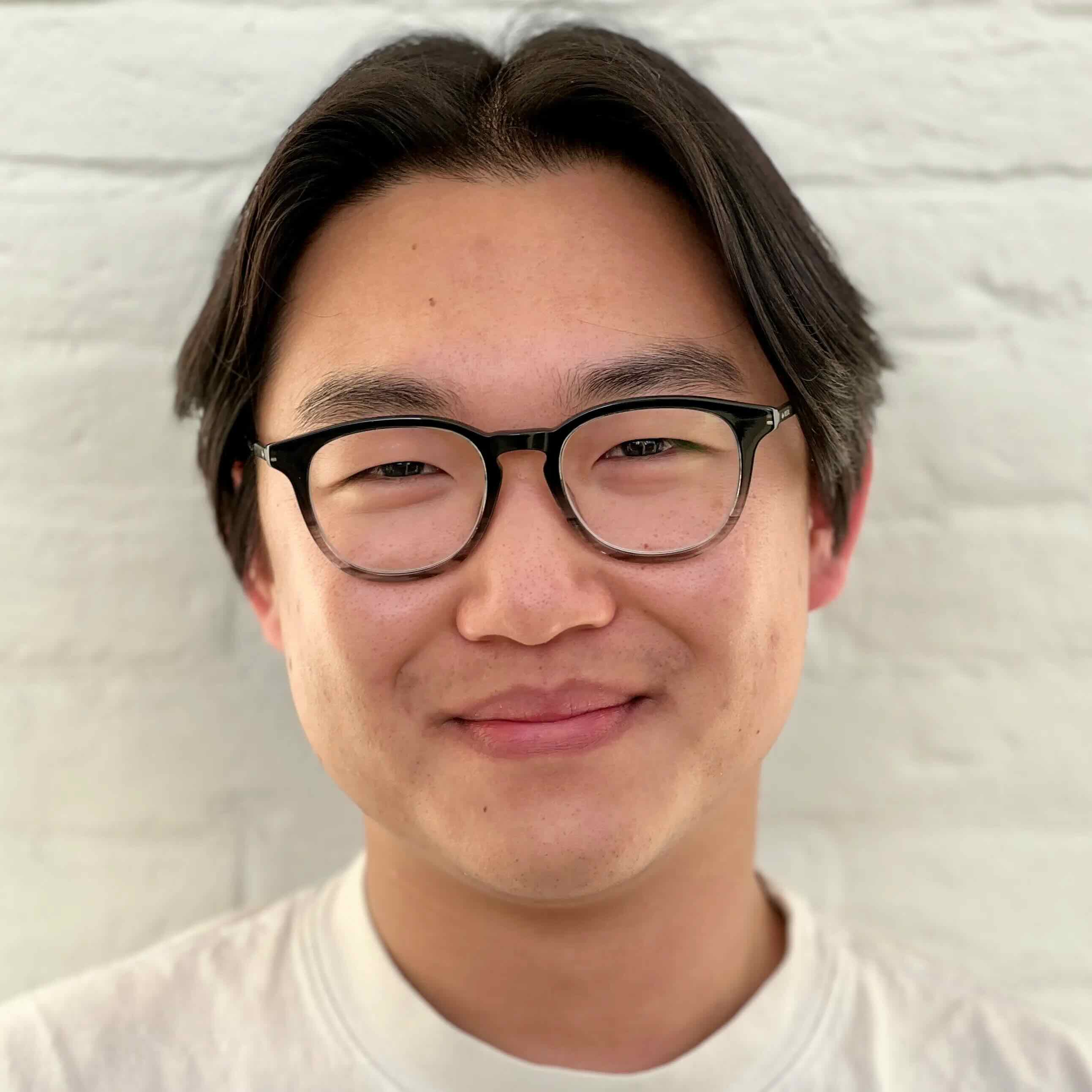 kevin in front of a white brick wall